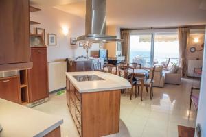 a kitchen and living room with a view of the ocean at Alexander Seaside in Preveza