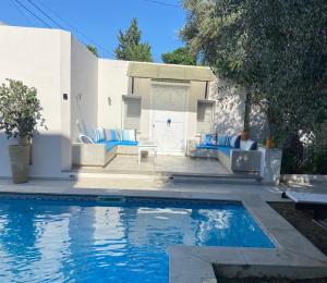 a swimming pool in front of a house at Dar Misk in La Soukra