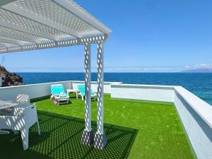 a patio with a view of the ocean at Casa Ale, Stunning Sea Views in Las Aguas