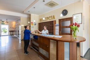 two women standing at a counter in a pharmacy at DIUNA Łeba in Łeba