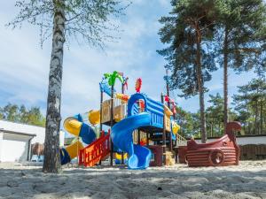 a playground with a slide in the sand at DIUNA Łeba in Łeba