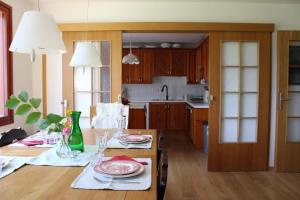 a kitchen with a table with plates on it at Panoramic Forest Chalet Bled Lake and Castle View in Bled