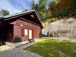 a small wooden building with a grass yard at Panoramic Forest Chalet Bled Lake and Castle View in Bled