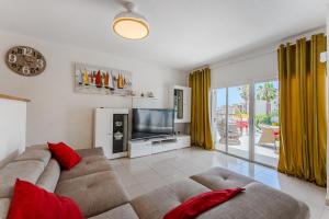 a living room with a couch and a television at Ocean View Duplex Tenerife ( Golf del Sur) in San Miguel de Abona
