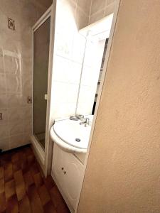 a bathroom with a sink and a mirror at Appartment Cap d'Agde in Cap d'Agde