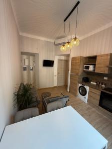 a kitchen and living room with a table and chairs at Sabrina's House in Milan