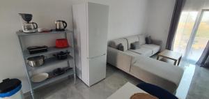 a living room with a couch and a table at Heracles Guest house in Nea Peramos