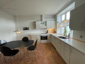 a kitchen with a table and chairs and a sink at Kongensgade (ID 161) in Esbjerg