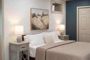 a bedroom with a bed and two tables with lamps at Pickleball - Sleeps 14 - 151 Brew Trail - Firepit in Nellysford