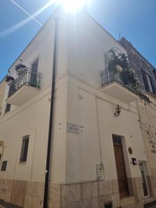a white building with two balconies on top of it at B&B Novecento Italiano in Altamura +67 photos