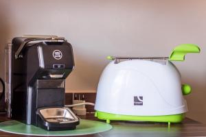 a white and green toaster sitting on a counter at White Beach in Alghero