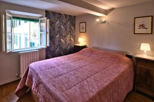 Postel nebo postele na pokoji v ubytování Corte Dei Portici + 7 fotografií