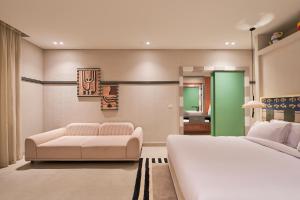 a bedroom with a white bed and a couch at Good Days Caesar in Ras Elhekma +23 photos