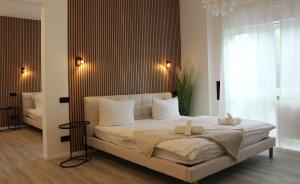 a bedroom with a large bed with two towels on it at DREAMSPACE Frankfurt Airport in Kelsterbach +5 photos