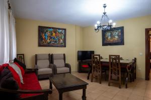 a living room with a table and a dining room at Panther Home VillaDolores in La Alberca +17 photos
