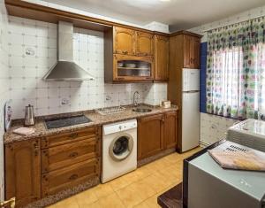 a kitchen with a washing machine and a sink at Panther Home VillaDolores in La Alberca