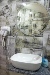 a bathroom with a sink and a mirror at Aronia Kazbegi in Stepantsminda