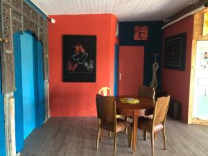 a dining room with red walls and a wooden table at Liber'Terre in Andouque