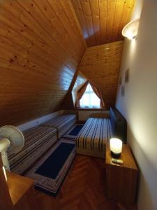 an attic room with two beds and a window at Dessewffy Guesthouse in Zamárdi +53 photos