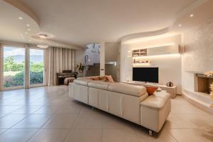 a living room with a large couch and a television at Villa Angela in Capannori
