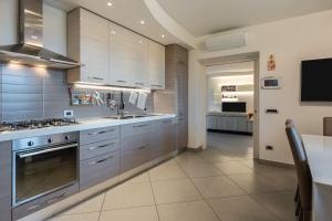 a kitchen with stainless steel appliances and a dining room at Villa Angela in Capannori