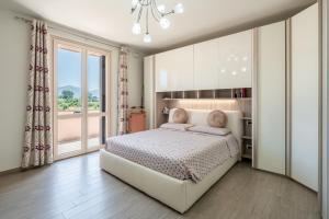 a bedroom with a bed and a large window at Villa Angela in Capannori +23 photos