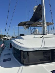 a white boat is docked in the water at Spacious 52 ft Catamaran for Dockside Stay in Key West +20 photos