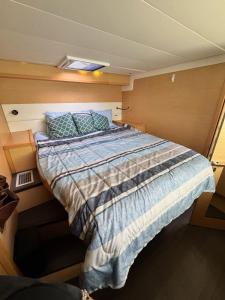 a large bed in a small room on a boat at Spacious 52 ft Catamaran for Dockside Stay in Key West