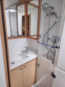 a bathroom with a sink and a shower at Spacious 52 ft Catamaran for Dockside Stay in Key West