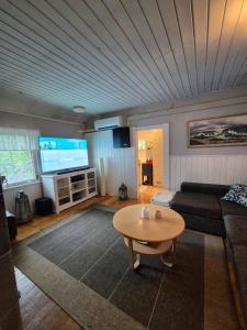 a living room with a couch and a table at Kutala Cottage in Kutala