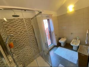 a bathroom with a shower and a sink and a toilet at Casa Maia in Baveno