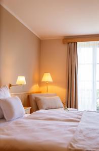 a hotel room with two beds and a window at Casa Firmenich in Eckberg