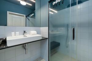 a bathroom with a sink and a shower at Cosy Apartment Parking & Balcony Close to the Kępa Redłowska by Noclegi Renters in Gdynia