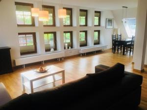 a living room with a couch and a table at Ferienglück Lindwedel in Lindwedel +23 photos