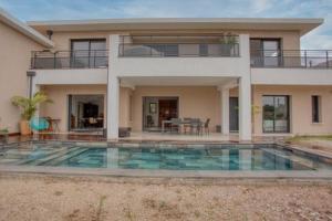 a house with a swimming pool in front of a house at Dolce Vita in Fréjus