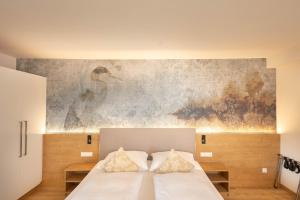 Postel nebo postele na pokoji v ubytování Hotel Garni Wurzer