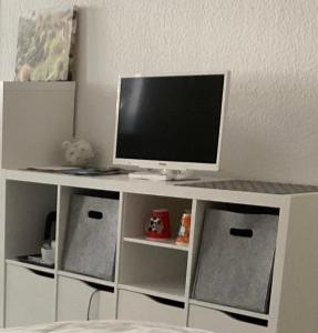 a tv sitting on top of a white entertainment center at Pension SPORT-SCHMIEDE in Schmiedefeld am Rennsteig