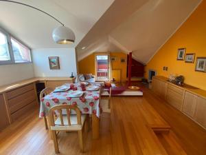 a dining room with a table and a kitchen at Casa Maia in Baveno