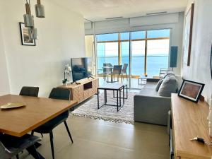 a living room with a couch and a table at Intempo by Holuxe - 176 - 17th floor in Benidorm