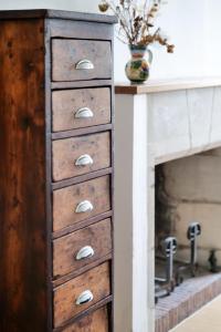 a wooden chest of drawers with a fireplace at Grand appartement cœur de ville d'Angers - 5 personnes in Angers