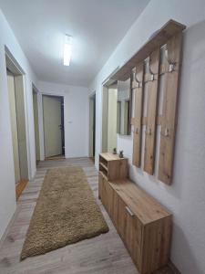 a hallway with wooden cabinets and a rug at Sobe Gornja Trepca in Gornja Trepča