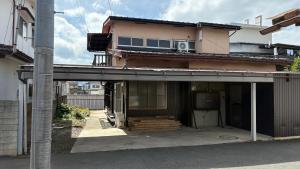 a house with a balcony on top of it at WAVILLA mihata cho in Yamagata