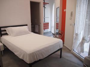 a bedroom with a bed with white sheets and a window at Hotel Vienna in Pesaro +164 photos