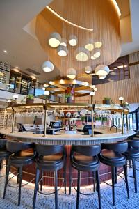 a bar with stools in a restaurant at City Lodge Hotel V&A Waterfront in Cape Town