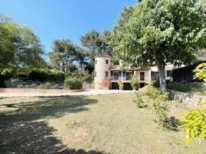 a large house with a tree in front of it at La Villa Lou Castel in Sanary-sur-Mer