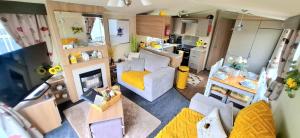 a living room with a couch and a kitchen at The Humble Bee in Cleethorpes