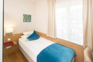 Postel nebo postele na pokoji v ubytování Hotel Garni Wurzer
