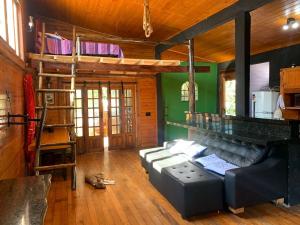 a living room with a couch and a bunk bed at Cabana Urbana in Cascavel