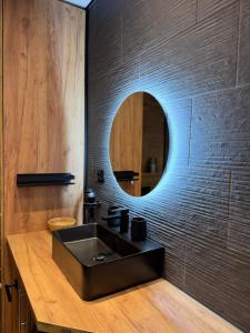 a bathroom with a black sink and a mirror at Bay View Village - Villa Eléanore 1 in Herceg-Novi