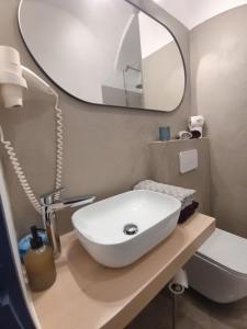 a bathroom with a sink and a mirror at Bratislava center - blue apartment in Bratislava
